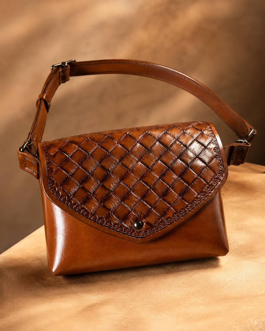 Brown basketweave tooled leather shoulder bag.