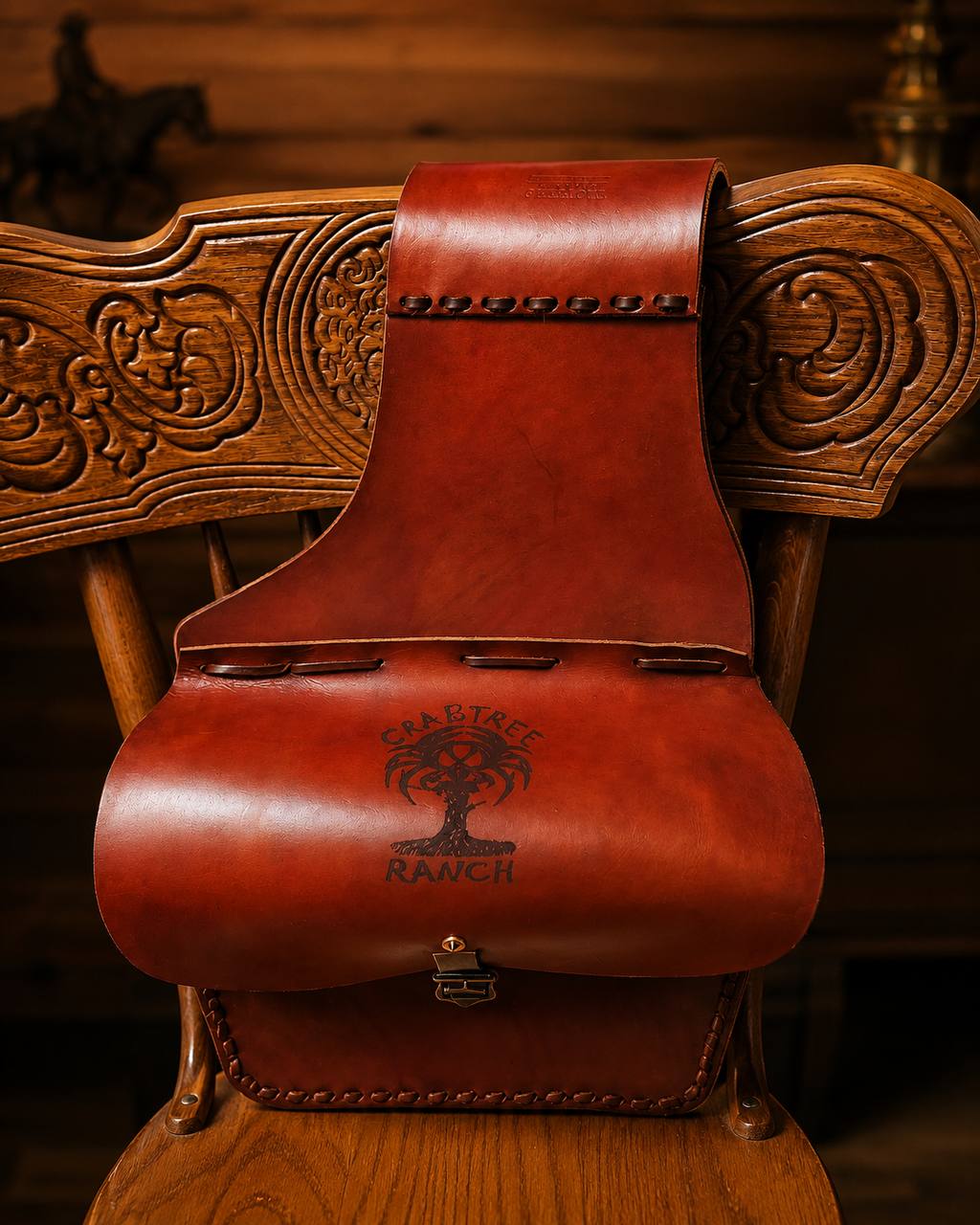 Brown Crabtree Ranch leather saddle bag on a chair.