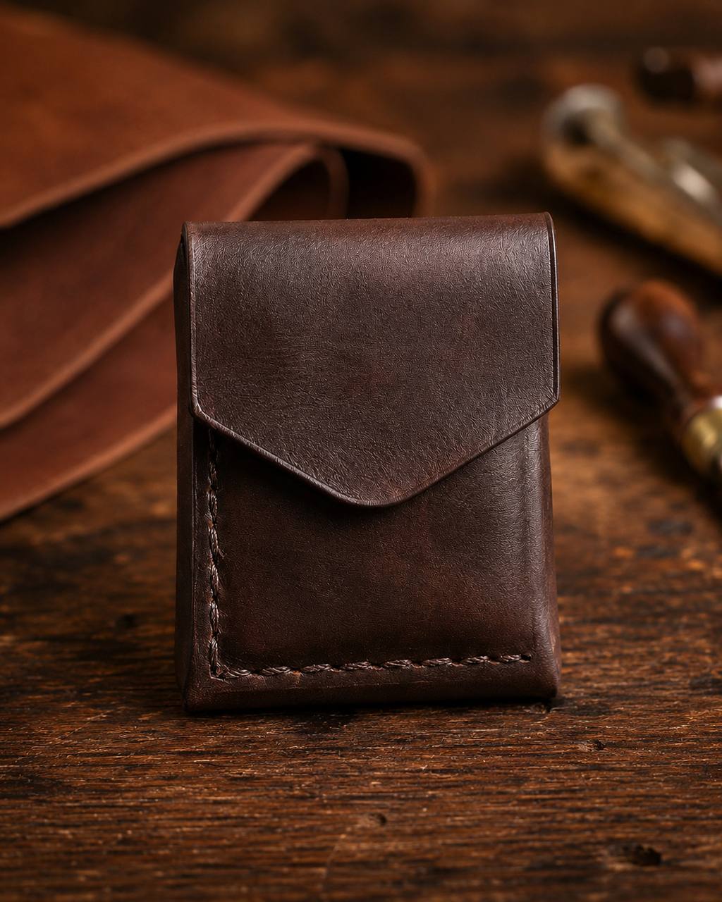 Dark brown leather pouch with flap closure.