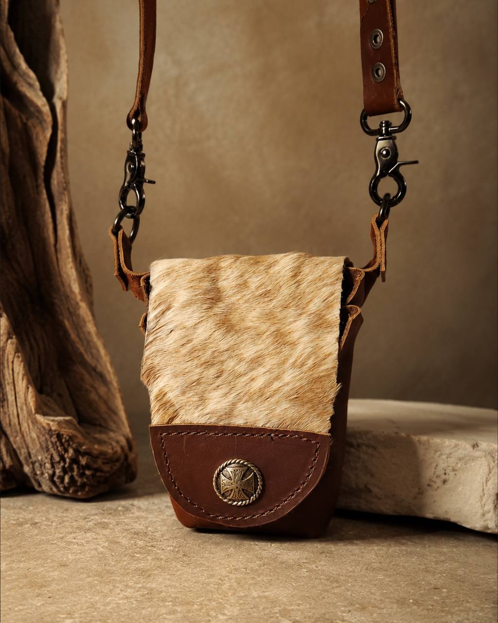 Small hair-on-hide leather crossbody bag.