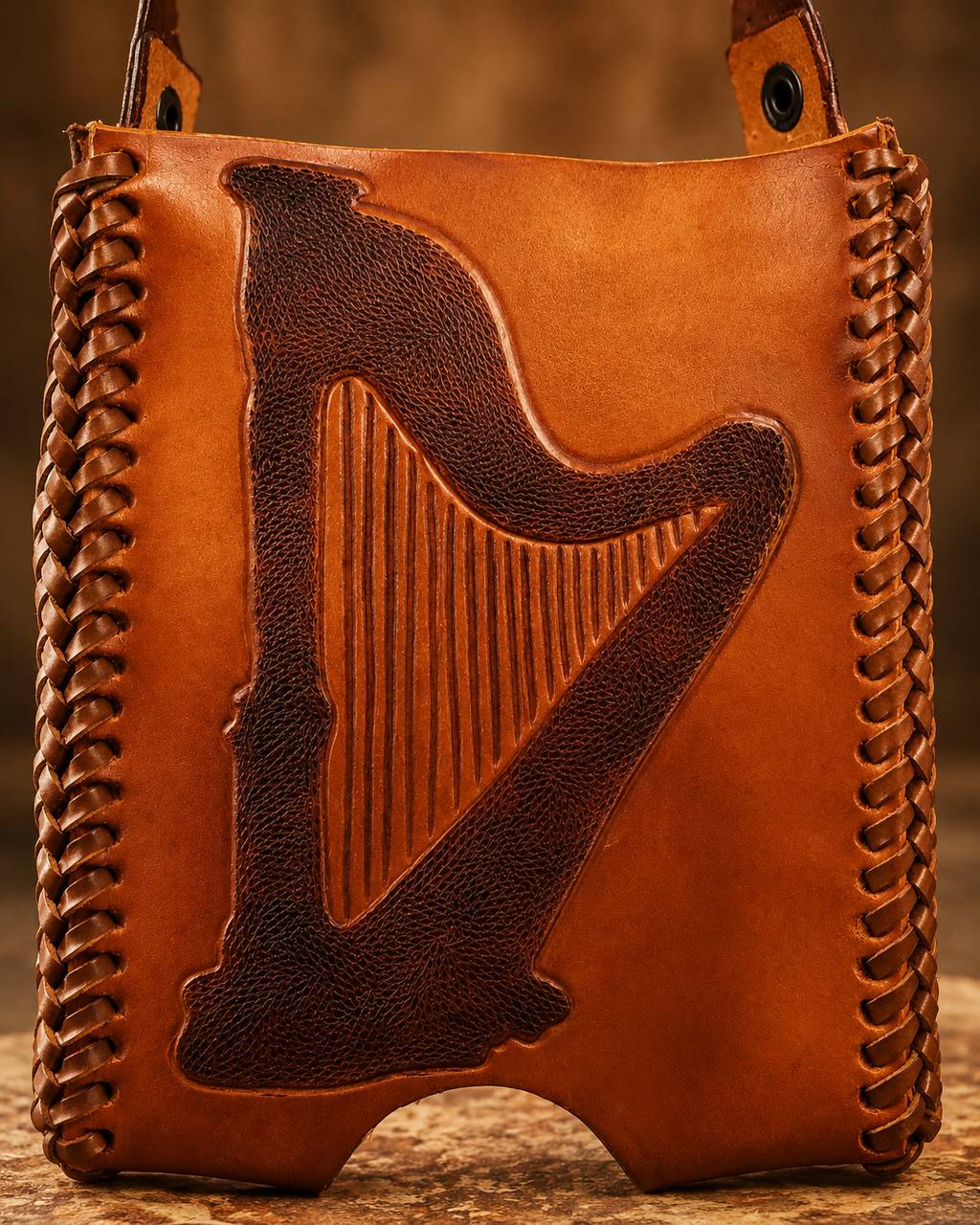 Tooled leather harp holder front view.
