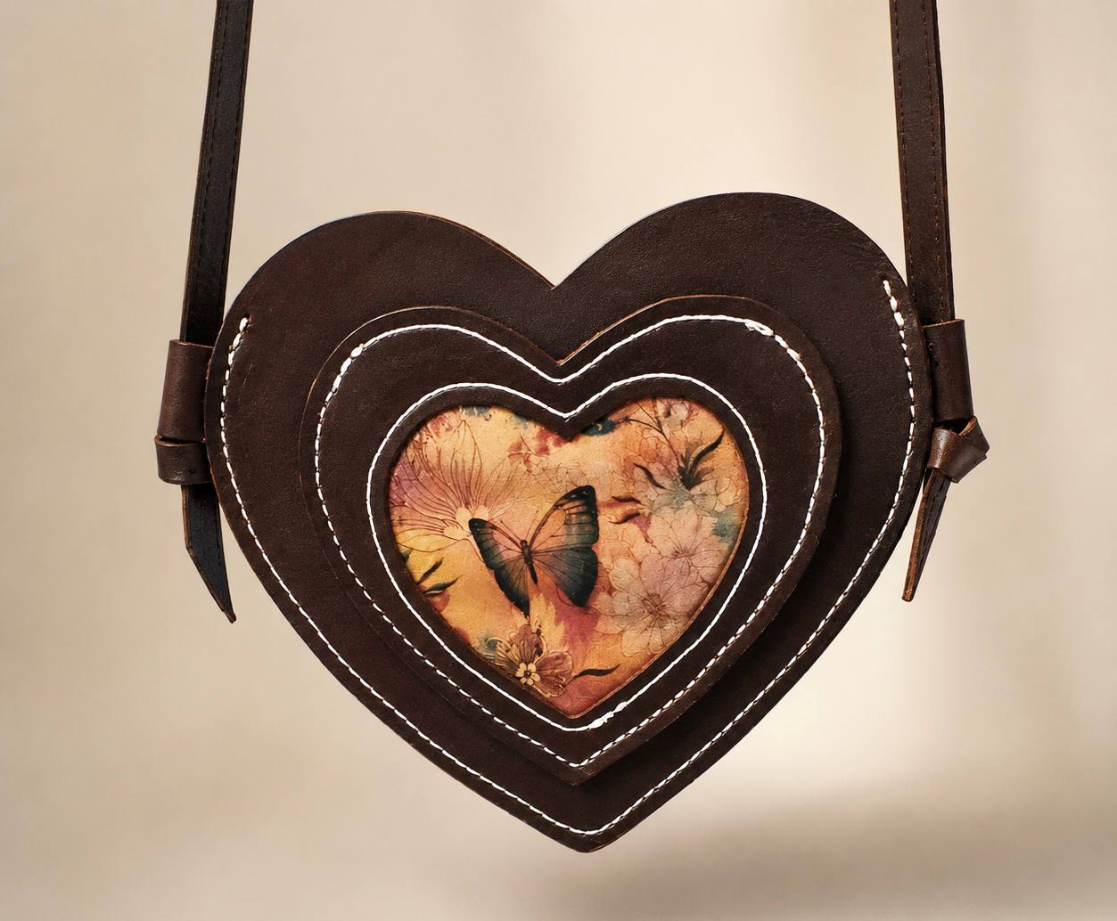 Heart shaped leather purse with butterfly detail.