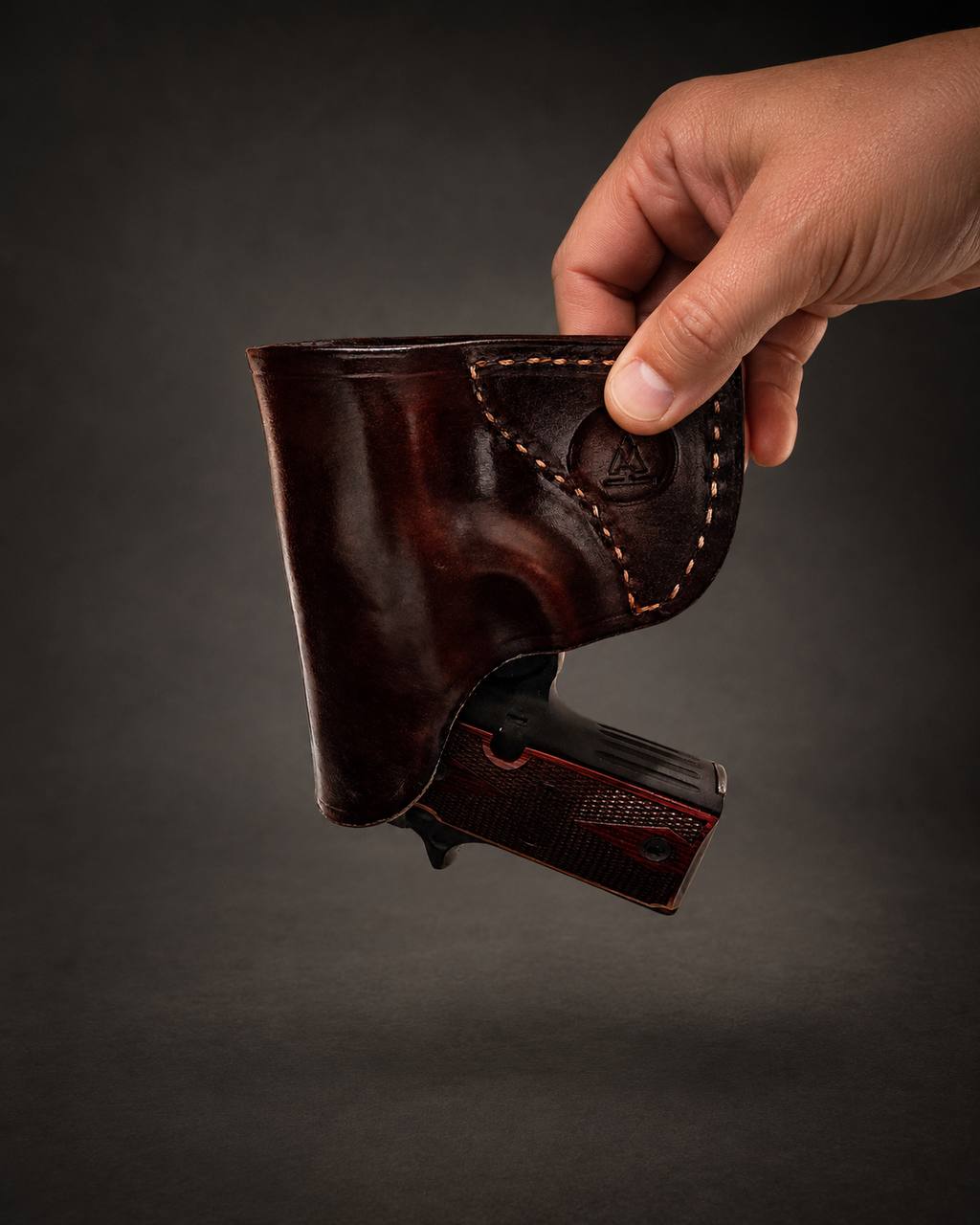 Brown leather holster with hand stitching.