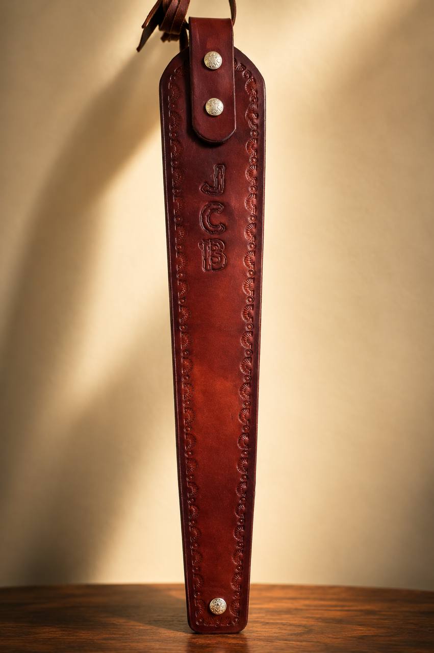 Close-up of a JCB tooled leather rifle strap.