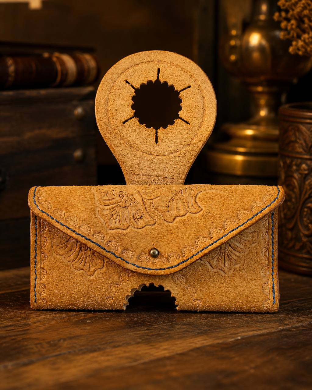 Light tooled leather custom holder with blue stitching.
