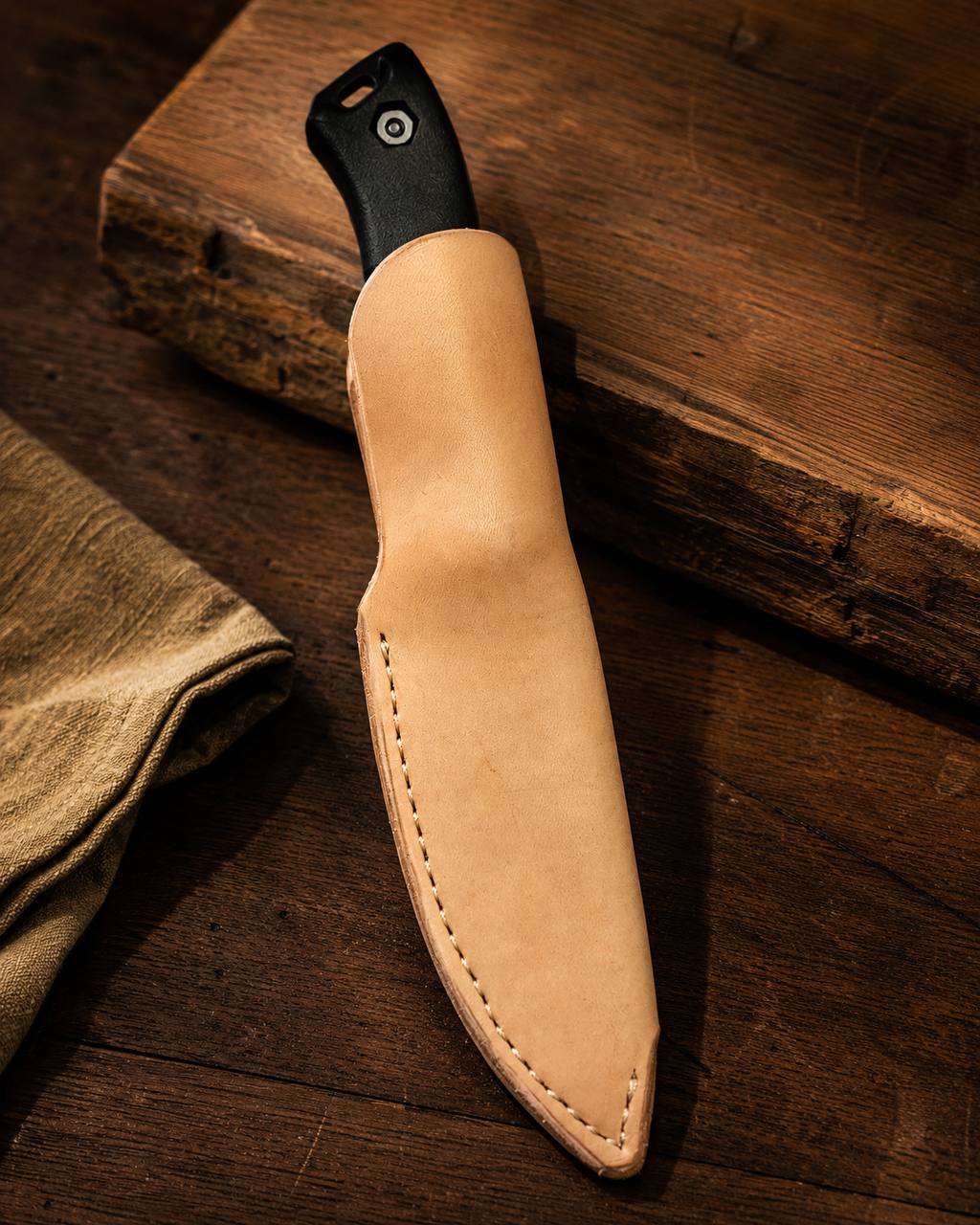 Natural leather knife sheath with black knife handle.