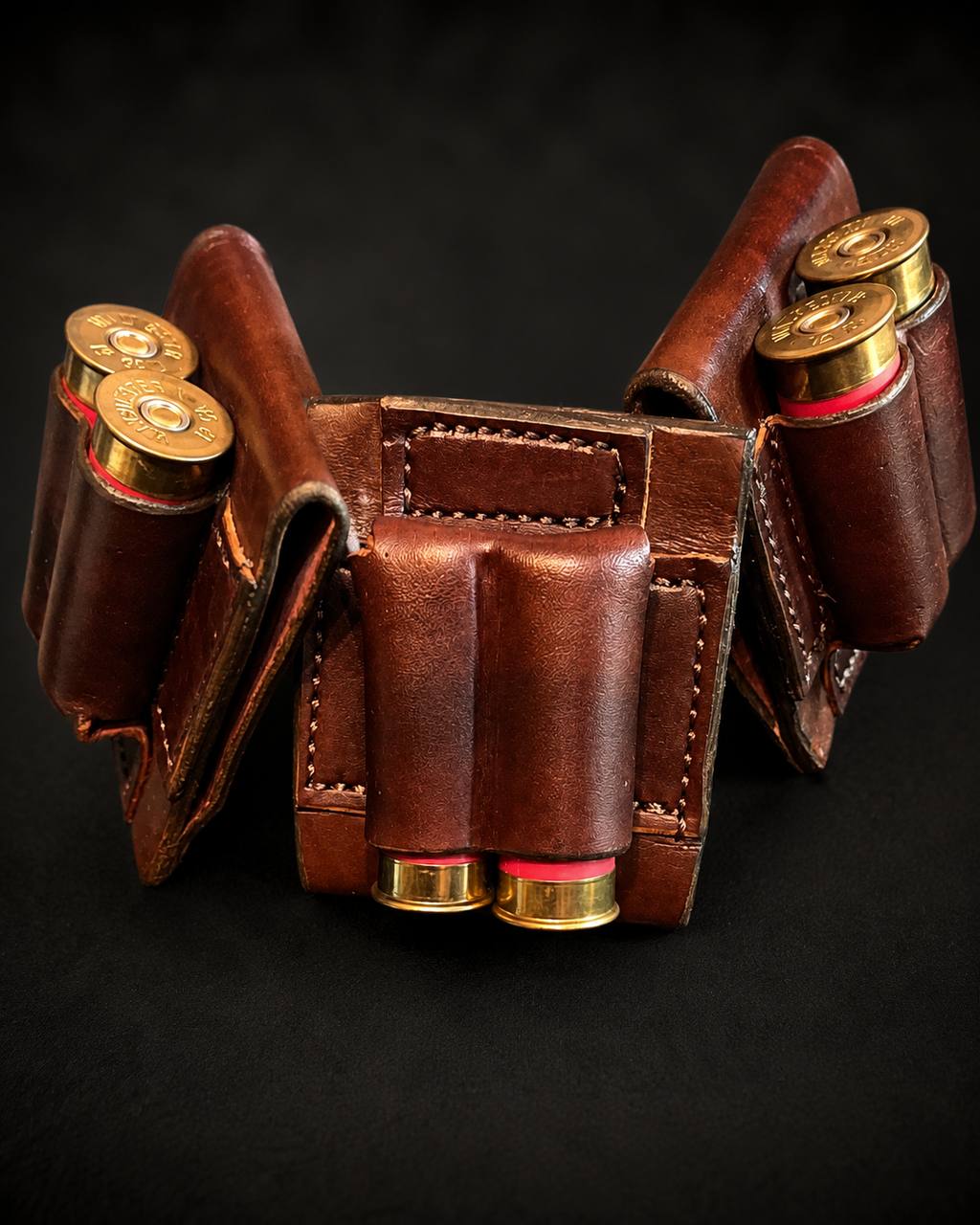 Leather shell carrier with shotgun shells.