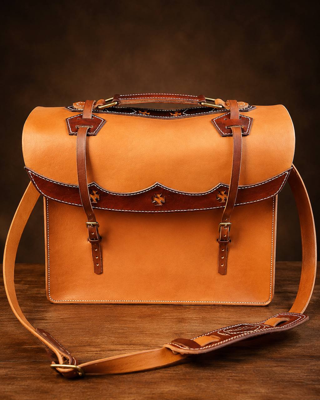 Front view of a tan western leather satchel.