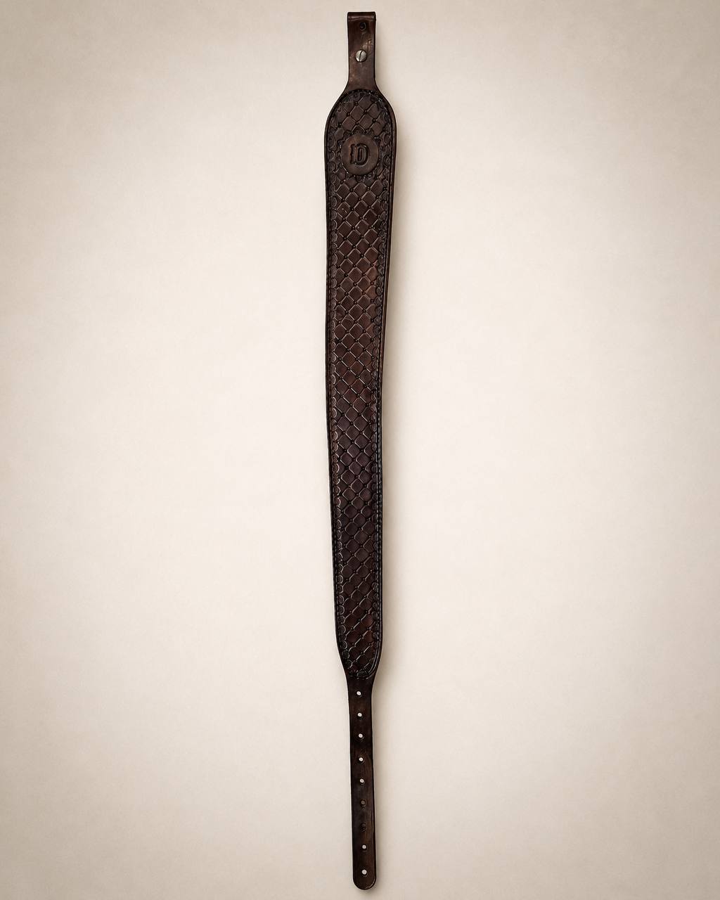 Long dark tooled leather music strap.