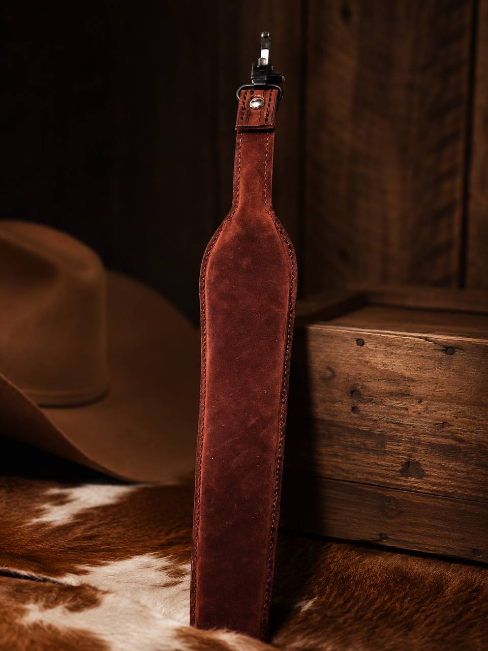 Back view of a tooled leather rifle strap.