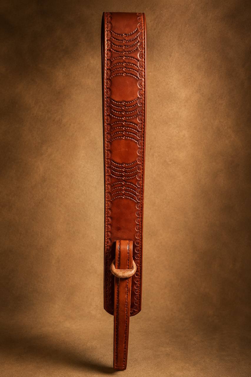 Tooled leather rifle strap with buckle.