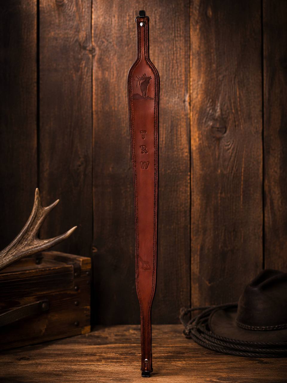 Front view of a tooled leather rifle strap.