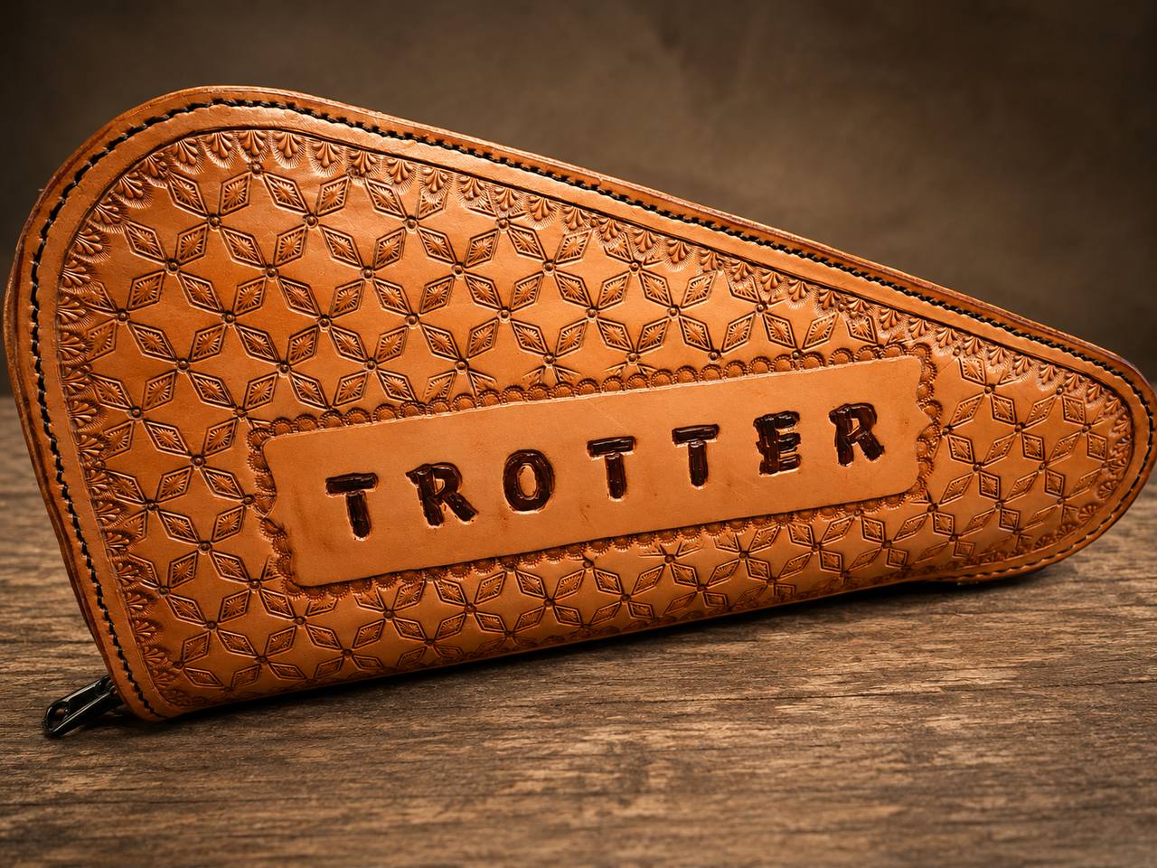 Tooled leather holster case with Trotter name panel.