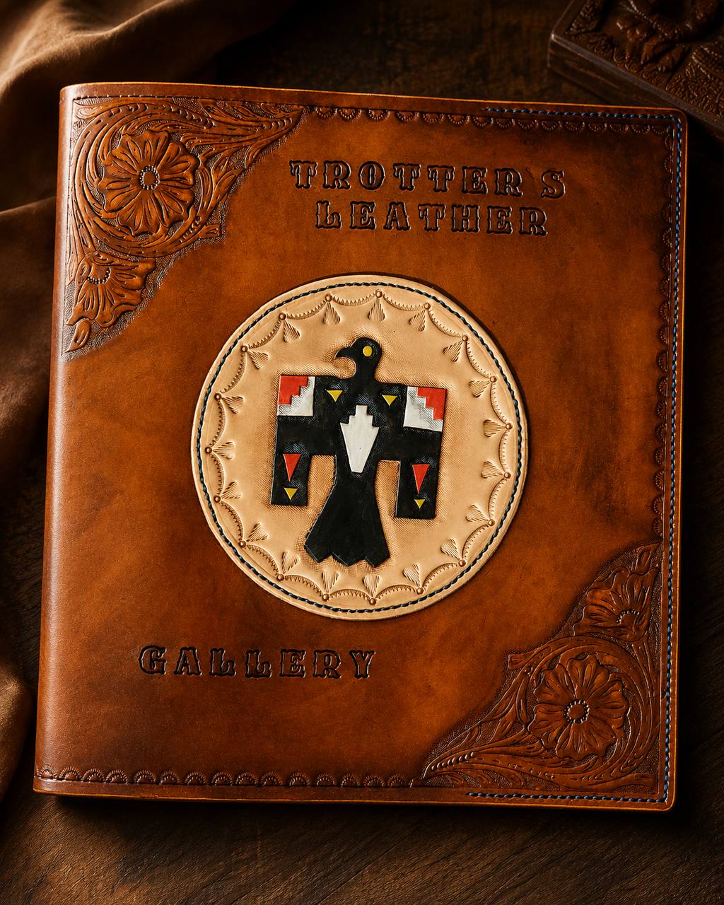 Tooled Trotter's Leathers gallery cover with thunderbird design.